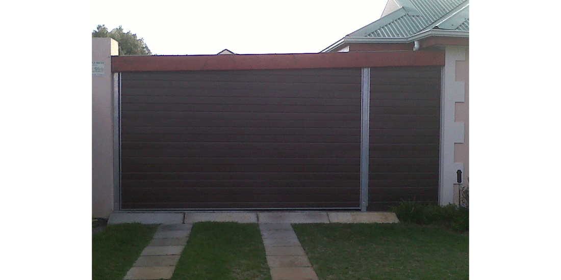 Double bronze horizontal slatted aluzinc tip up door with fixed side panel and galvanised steel posts
