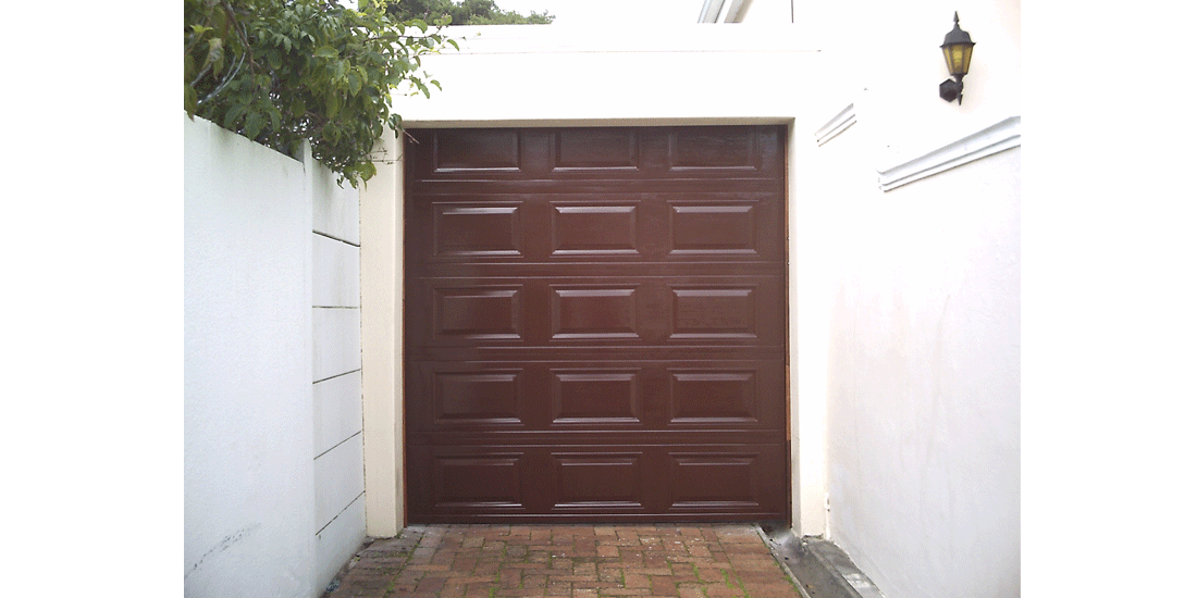 Single brown raised & fielded aluzinc tip up door - Supplier B